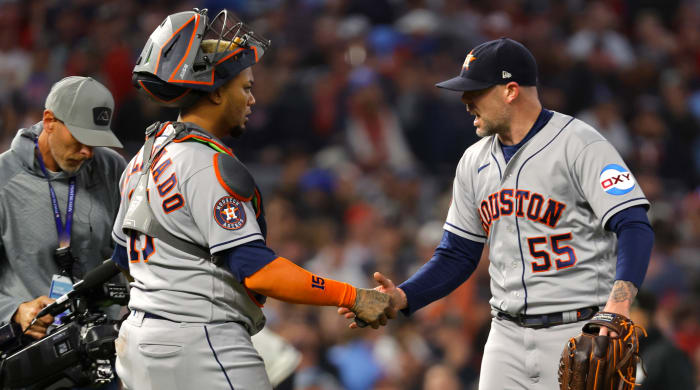 Astros relief pitcher Ryan Pressly (right) shakes hands with catcher Martín Maldonado after the ninth inning of Game 4 of the ALDS.